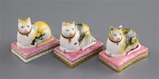 Three Derby porcelain figures of recumbent cats, c.1810-25, L. 4.4cm, one with restored ears